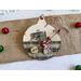 ornament with candy cane background, includes buttons, cranberry pips, a stamp, mini ticket strip, and a mini ornament tag.